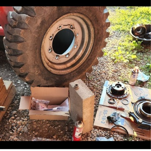 How do I remove the old front wheel bearings on a Massey Ferguson 1720