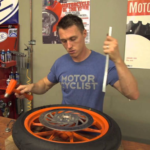 What's the step-by-step process for removing a motorcycle wheel bearing